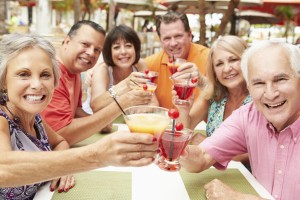 Group Of Senior Friends Enjoying Cocktails In Bar Together